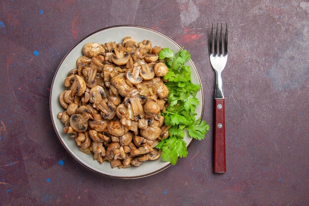 Top view delicious cooked mushrooms with greens on dark background dish dinner meal food plant wild