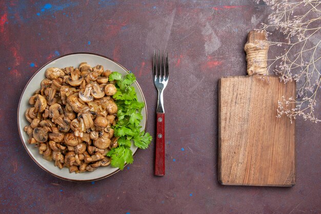 Top view delicious cooked mushrooms with greens on the dark background dish dinner meal food plant wild