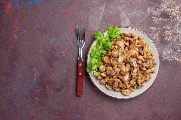 Top view delicious cooked mushrooms with greens on dark desk food wild dinner plant meal