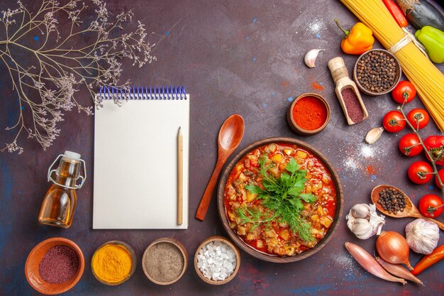 Top view delicious cooked vegetables sliced with different seasonings on a dark background soup food sauce meal vegetable