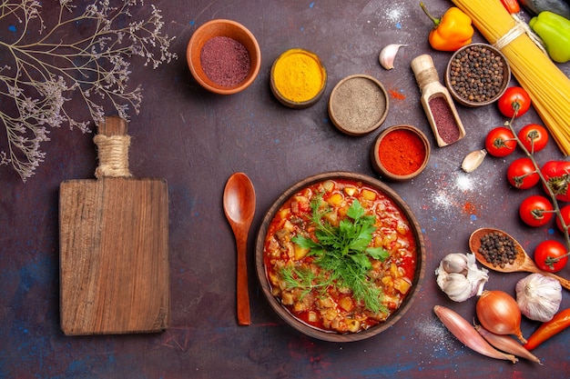 Top view delicious cooked vegetables sliced with different seasonings on dark desk soup food sauce meal vegetable