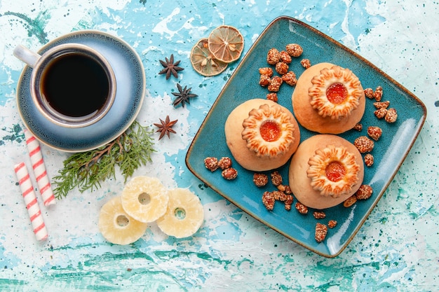 Top view delicious cookies with coffee on light blue surface cookie biscuit sweet sugar color