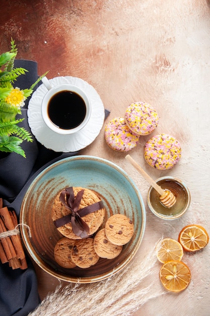 Top view delicious cookies with cup of coffee and biscuits on light surface dessert sweet cake tea horizontal dough sugar biscuits