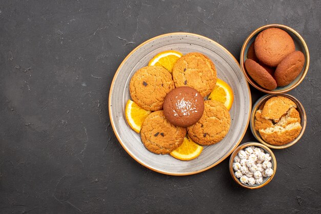 Top view delicious cookies with fresh sliced oranges on a dark background cookie biscuit fruit sweet citrus cake