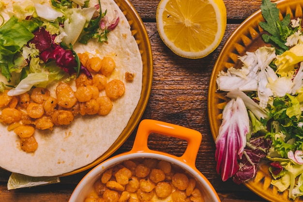 Top view of delicious corn dish with vegetables on table