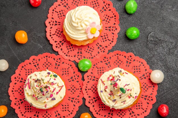 Top view delicious cream cakes dessert for tea on dark-grey background cake cream biscuit sweet cookies dessert