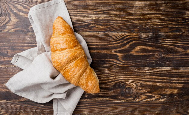 Top view delicious croissant on cloth