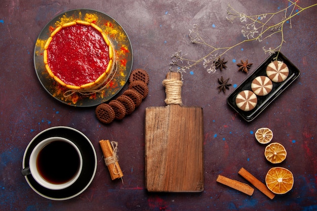 Top view delicious dessert cake with cup of coffee and cookies on the dark background biscuit sugar cookie cake dessert sweet