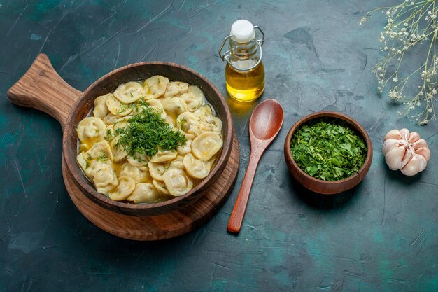 Top view delicious dumplings with greens on dark green desk food ingredient product dough meat vegetable