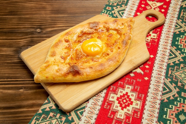 Top view delicious egg bread baked on a brown wooden desk