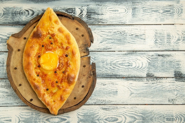 Top view delicious egg bread baked on a rustic grey space