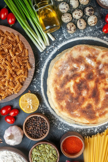 Vista dall'alto deliziose frittelle con ingredienti diversi, condimenti e pasta su sfondo scuro, pane, colore, cibo, panino