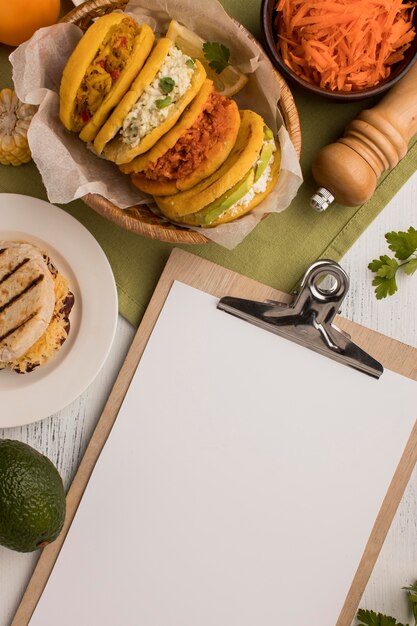 Top view delicious food and clipboard