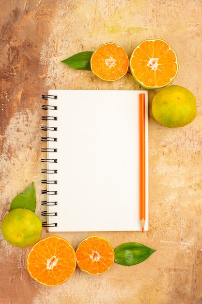 Top view delicious fresh tangerines with notepad