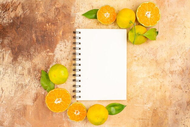 Top view delicious fresh tangerines with notepad