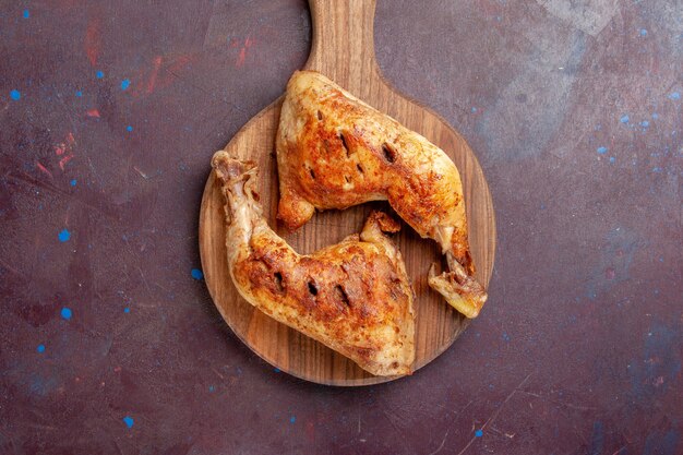 Top view delicious fried chicken cooked meat slices on dark desk