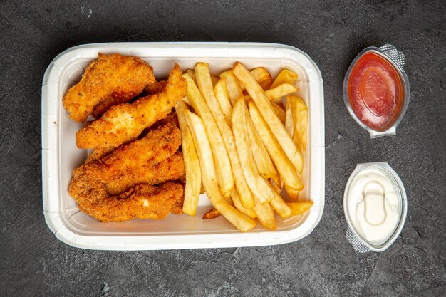 Top view of delicious fried chicken with french fries