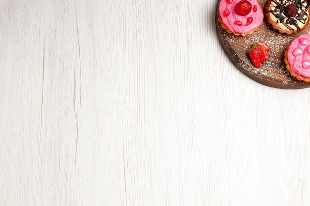 Top view delicious fruit cakes creamy desserts with fruits on light-white background cream tea dessert biscuit cake cookie