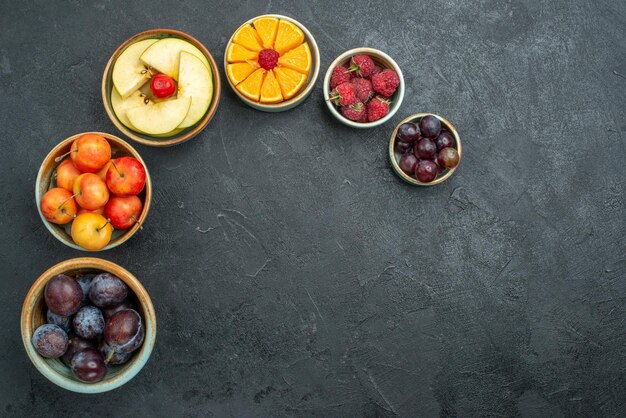 Top view delicious fruit composition fresh fruits on dark background ripe fresh health fruit mellow diet