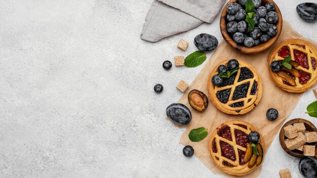 Top view of delicious fruit pies with copy space