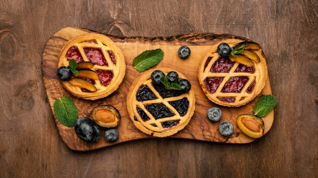 Top view of delicious fruit pies with plums