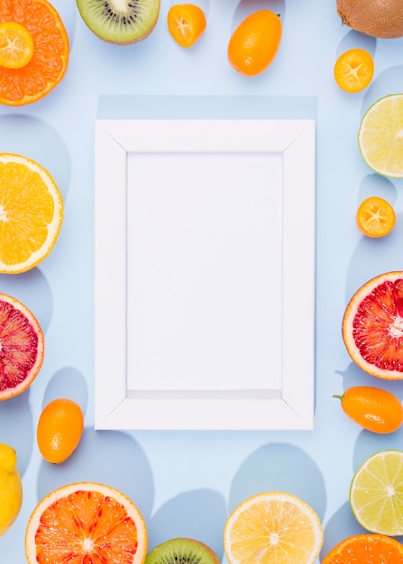 Top view delicious fruits with frame on the table