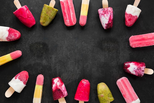 Top view of delicious fruity popsicles with copy space