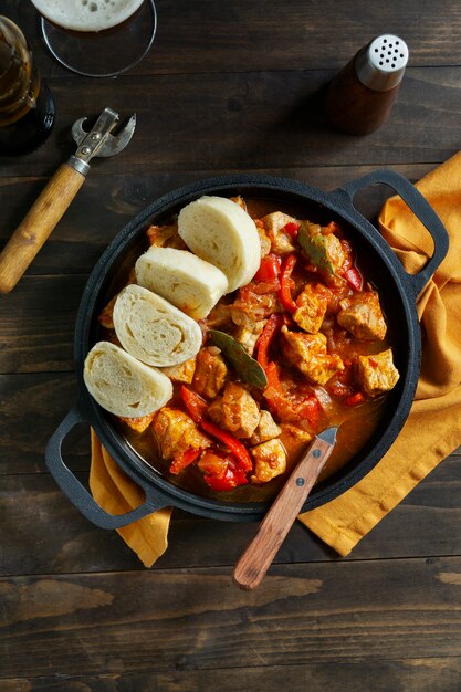 Top view delicious goulash and bread still life