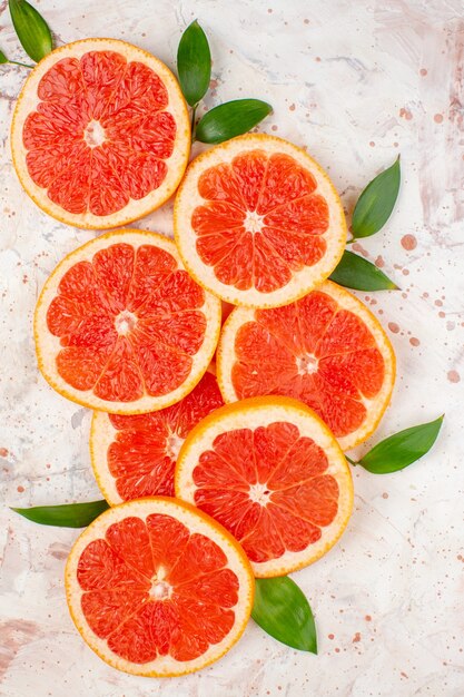 Top view delicious grapefruits slices lemon slices on nude table fruit photo