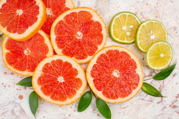 Top view delicious grapefruits slices lemon slices on nude table