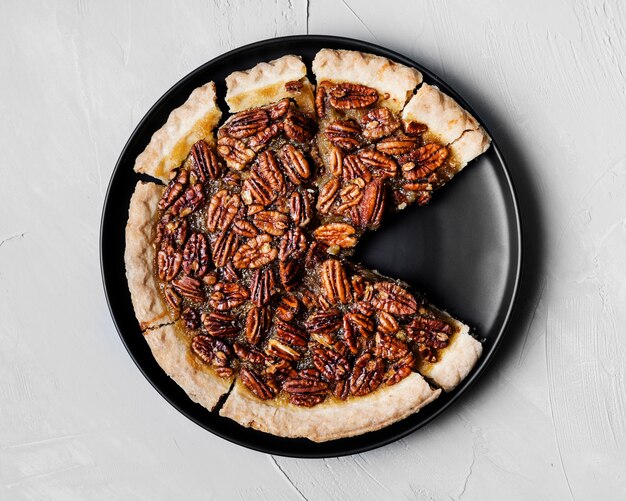 Top view delicious handmade pecan pie on a plate