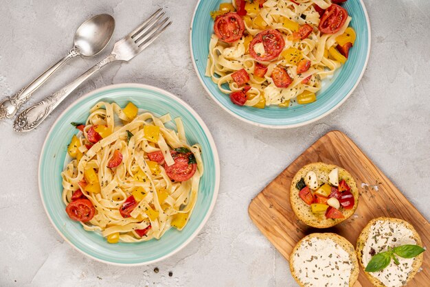 Top view of delicious italian food on plain background