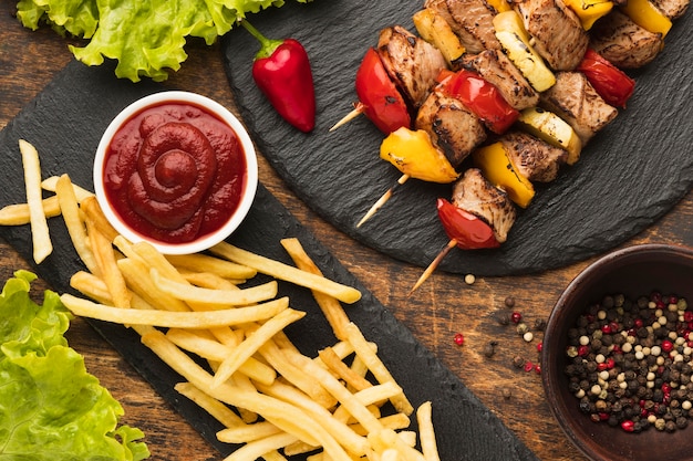 Top view of delicious kebab with french fries and ketchup