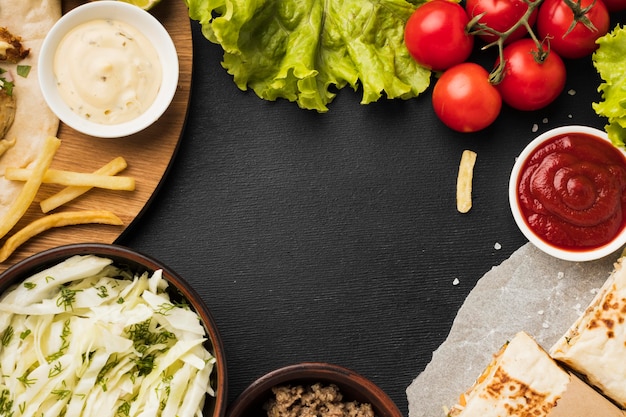 Top view of delicious kebab with ketchup and salad