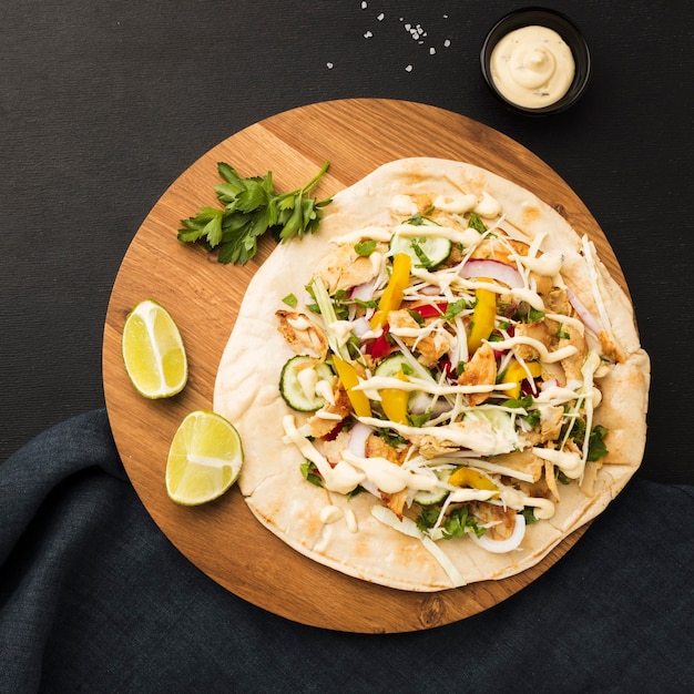 Top view of delicious kebab with limes and mayonnaise