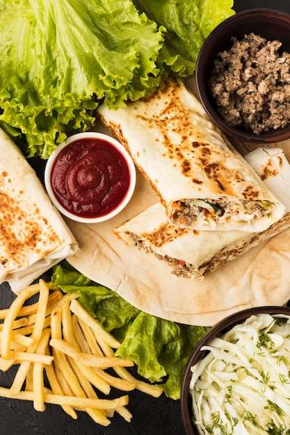 Top view of delicious kebab with salad and ketchup