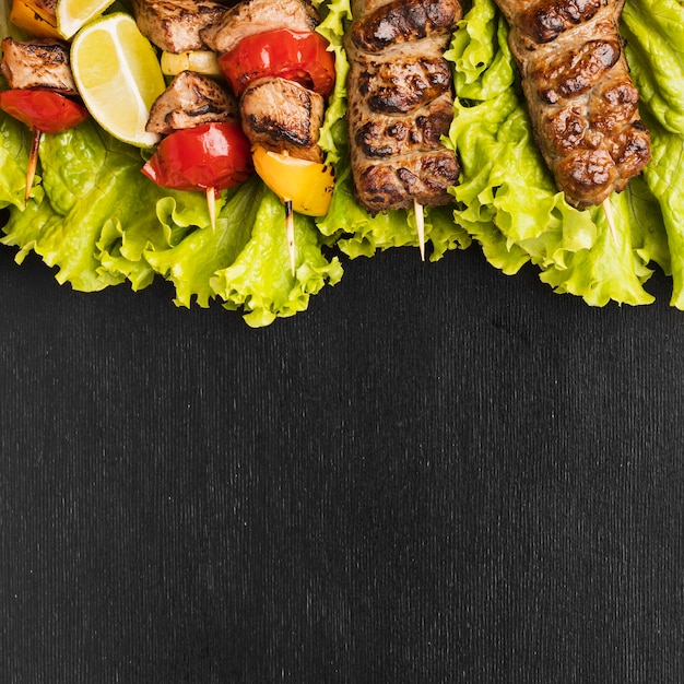 Free photo top view of delicious kebab with salad and meat