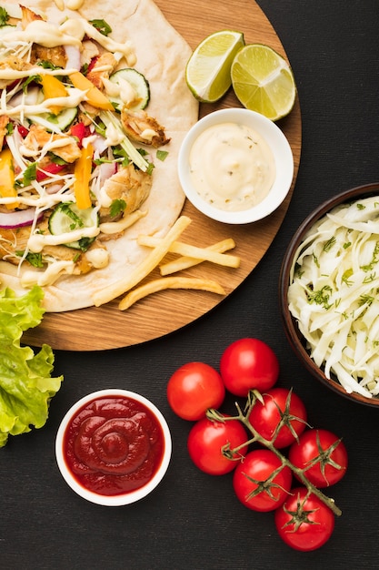 Top view of delicious kebab with tomatoes and limes