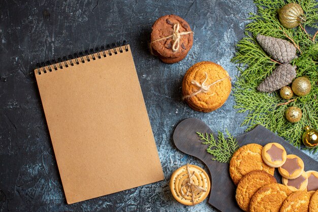 Top view delicious little biscuits with notebook