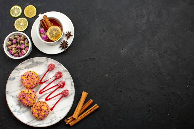 Top view delicious little biscuits with tea on grey space