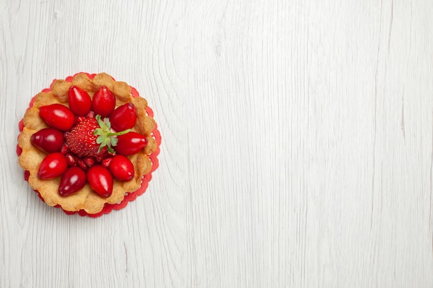 Top view delicious little cakes with fruits on light white desk