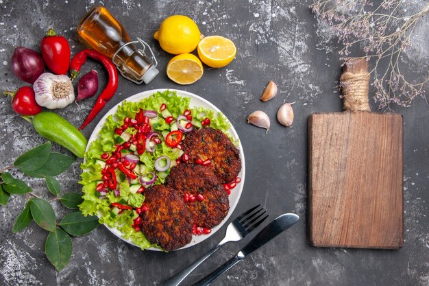 Top view delicious meat cutlets with fresh salad