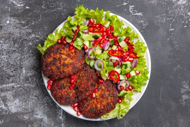 Top view delicious meat cutlets with fresh salad