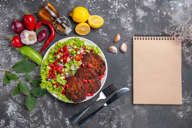 Top view delicious meat cutlets with fresh salad