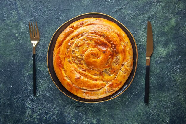 Top view of delicious meat pie on dark surface