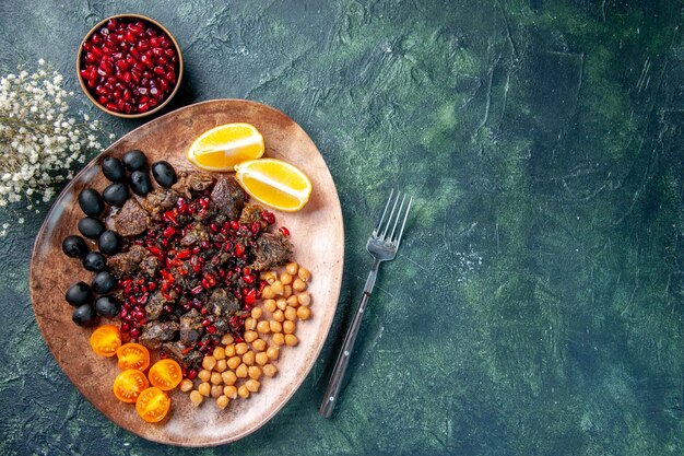 top view delicious meat slices fried with beans grapes and lemon slices inside plate, meal fruit meat dish food