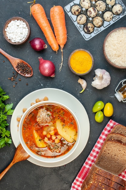 Top view delicious meat soup consists of potatoes beans and meat on dark background