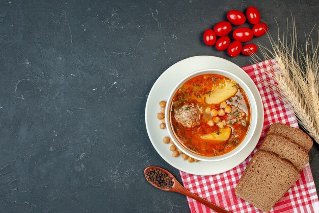 Top view delicious meat soup consists of potatoes and meat on dark background