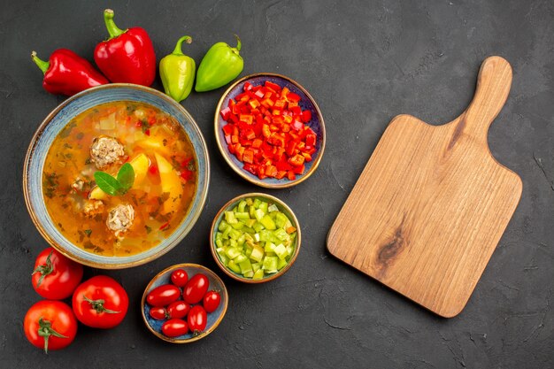 Vista dall'alto una deliziosa zuppa di carne con verdure fresche su cibo pasto foto piatto pavimento scuro