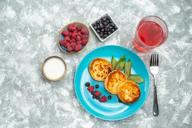 top view delicious muffins with berries on light background